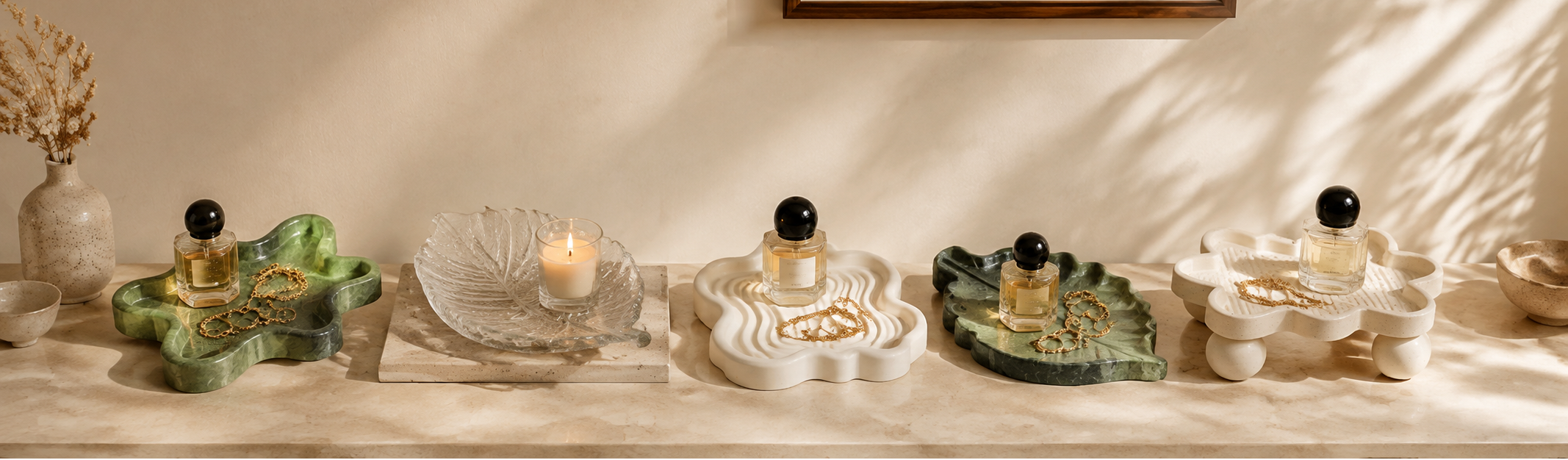A warm modern interior with sculptural tissue holders, natural stone, ceramic objects, wood and linen